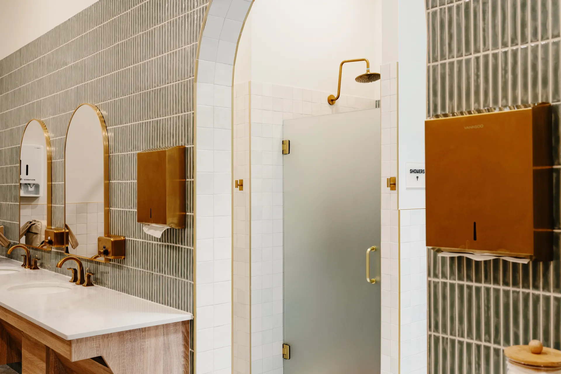 Showers and vanities in the women's locker room at THIS Gym